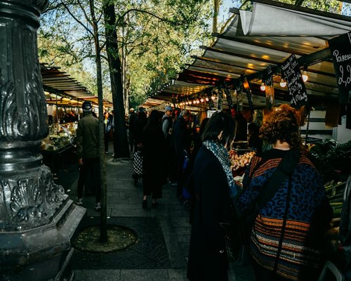 Person buying fresh vegetables at a local street market